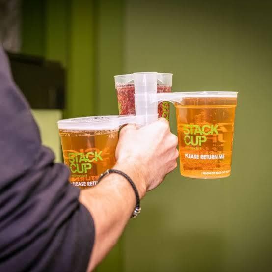 Crowd at a festival holding up reusable cups